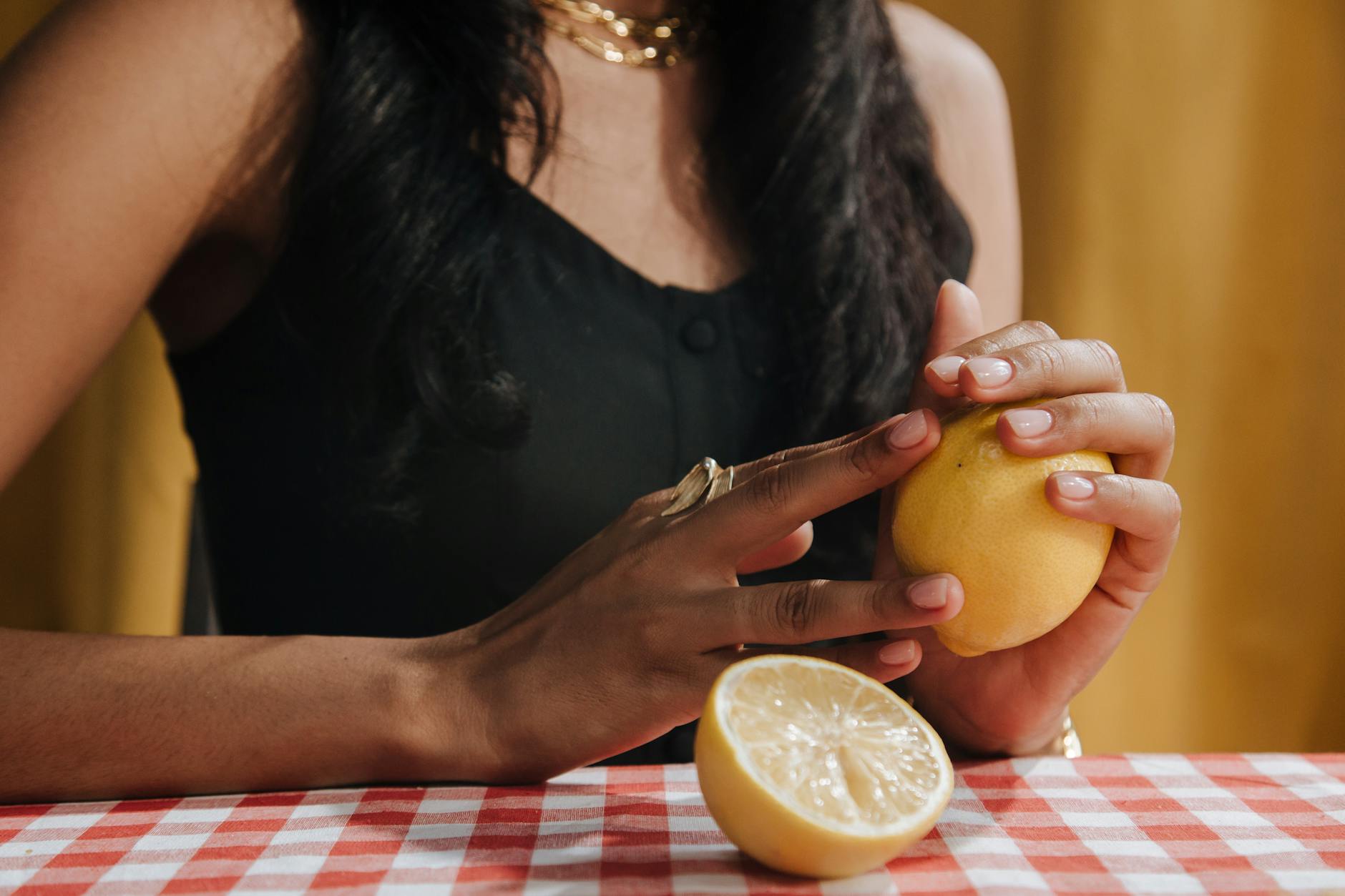 Vibrant lemons arranged on a yellow background in bright daylight